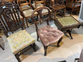 A Carolean style dining chair in carved oak with barley twist columns; a balloon back chair; a