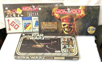 Two board games with original seals:  Monopoly & Pirates of the Caribbean Monopoly; a Star Wars