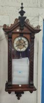 A 19th century small walnut cased wall clock in the Vienna style, with spring driven movement