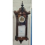 A 19th century small walnut cased wall clock in the Vienna style, with spring driven movement