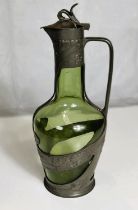An Art Nouveau "Orivit" green glass wine jug with raised pewter mounts, height 32cm (hinge a.f.).