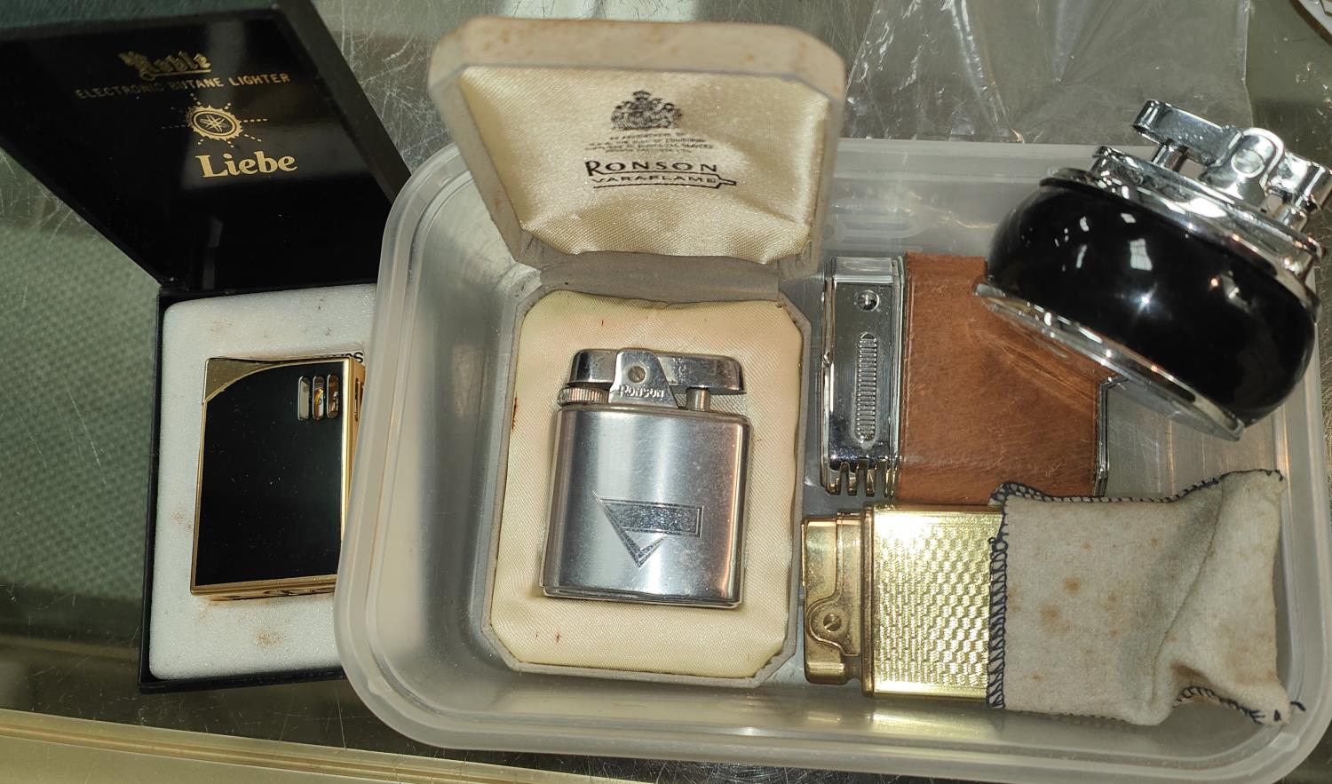 A vintage Ronson cigarette lighter, boxed; 4 others