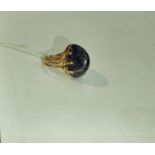 A yellow metal dress ring set yellow seamed lapis lazuli coloured stone, Egyptian marks to shank,