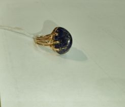 A yellow metal dress ring set yellow seamed lapis lazuli coloured stone, Egyptian marks to shank,