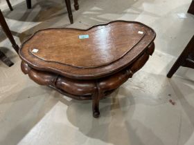 A 19th century Chinese hardwood stand with lotus leaf frieze, carried on 3 legs united by a shaped