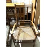 An Arts & Crafts rush seat armchair, turned legs and supports