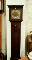 A mahogany cased, brass dial, granddaughter clock with chiming movement.