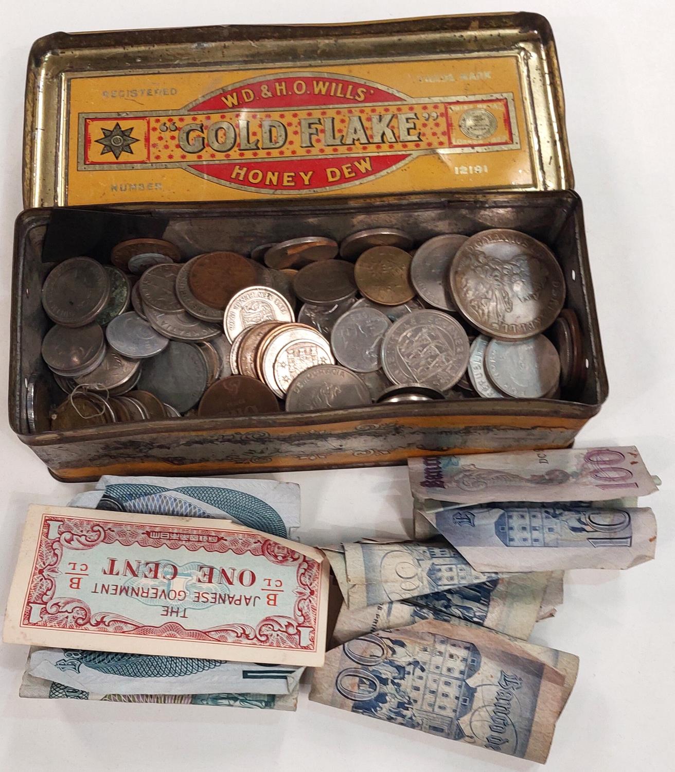 A small quantity of foreign coins, mainly European, in cigarette tin