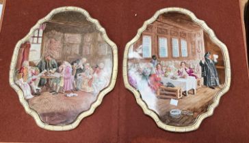 A pair of unusual porcelain plaques of shaped oval form decorated with 18th century figures dining