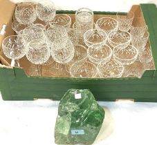 A green glass paperweight/doorstop and a selection of various drinking glasses