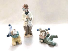 A Lladro clown playing a saxophone, impressed 5471, height 22cm; 2 x Nao boy clowns