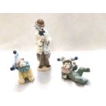 A Lladro clown playing a saxophone, impressed 5471, height 22cm; 2 x Nao boy clowns