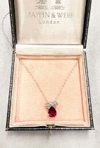 An 18 carat white gold pendant set large teardrop ruby and 6 diamonds