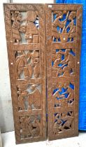 A pair of full height carved and pierced African wooden panels