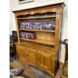 A large light wood satin finish traditional style farm kitchen style dresser with three hight