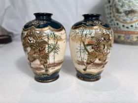 A small pair of Japanese satsuma vases, + dark turquoise ground with warrior to each panel,