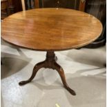 A Georgian mahogany occasional table with circular snap top, on turned column and triple splay feet,
