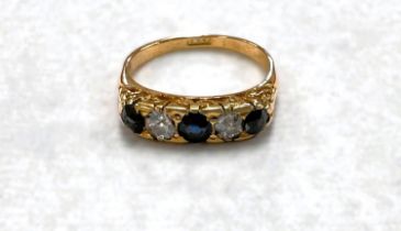 An 18 carat hallmarked gold ring with 3 sapphires and 2 sapphires set alternately, size N/O, 4gm
