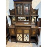 A 19th century full height rosewood side cabinet with mirror back and extensive marquetry inlay, the