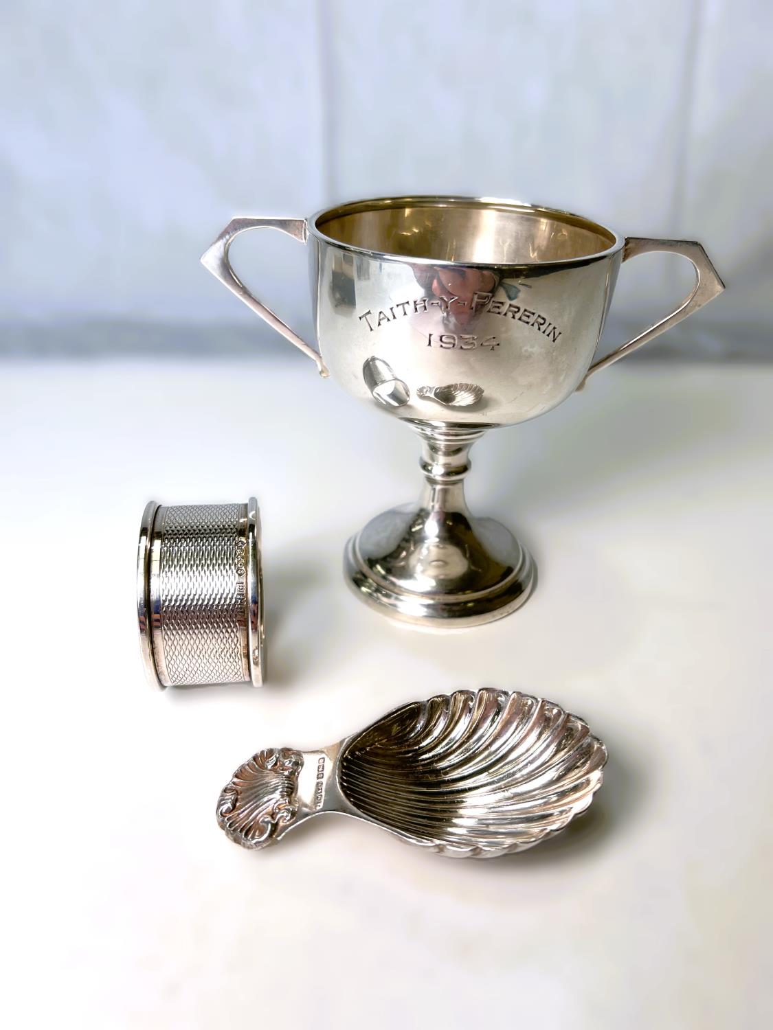 A hallmarked silver trophy double handle trophy cup, inscribed, Birmingham 1933/4; a shell bowl