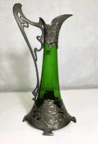A W.F.M. green glass claret jug of swelling form, with relief pewter mounts in the Art Nouveau