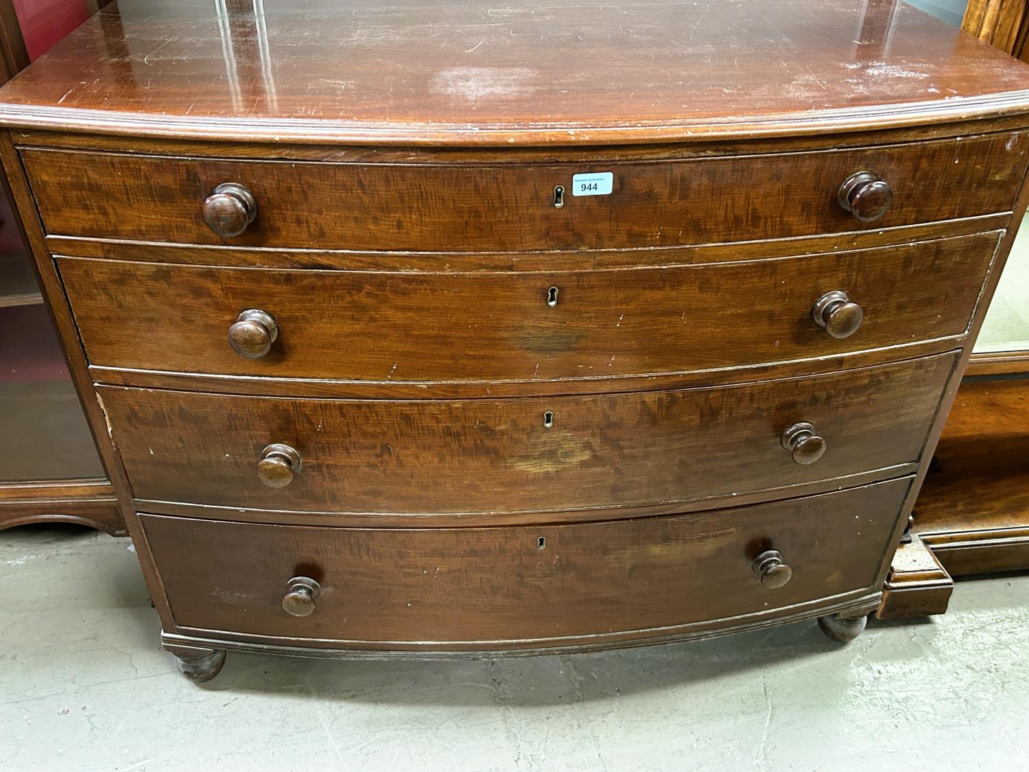 A Victorian mahogany bow front chest of 4 drawers, top originally fitted as secretaire, turned