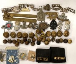 A selection of military badges and buttons relating to various regiments