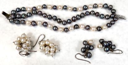 A 3 strand white and grey cultured pearl bracelet, knotted, a similar pair of earrings and another