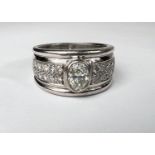 A gent's heavy dress ring with wide white metal shank set with central oval diamond approx. 1.06