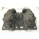 A pair of good sized bronzed composition threshold lions reclining, length 45cm
