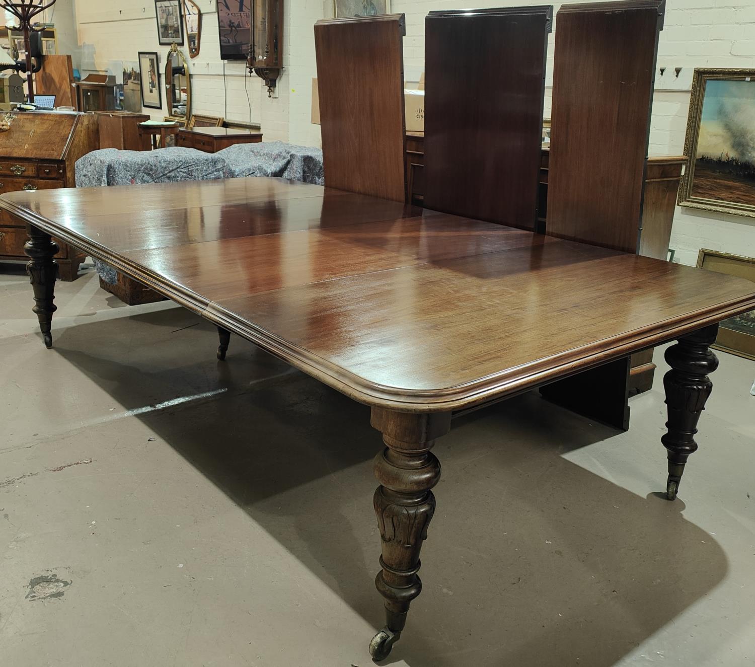 Banqueting Dining Table: A mid 19th century large and impressive rounded rectangular mahogany wind