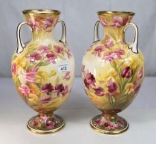 A pair of late 19th/early 20th century baluster vases by Crescent decorated with roses; a musical