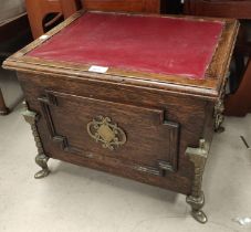 A brass mounted oak box seat/stool; a fireside companion set