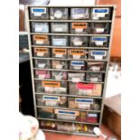 A Watch makers cabinet filled with spare parts, etc