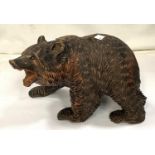 A Black Forest carved bear, length 28cm