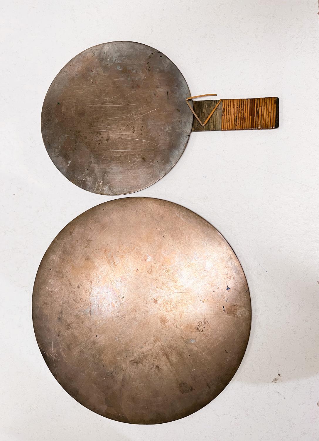 Two Chinese bronze mirrors, one highly polished side, the other embossed, one with handle
