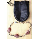 A white metal Scandinavian necklace with diamond links and red agate in leather Hoopers Bolton bag
