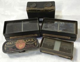 An early 20th century stereoscope viewer and 3 boxes of glass viewing slides and a "Patheorama"