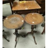 A burr walnut nest of three occasional tables with rectangular dish tops and a pair of pedestal wine