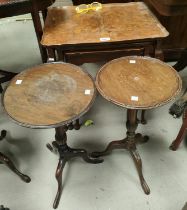 A burr walnut nest of three occasional tables with rectangular dish tops and a pair of pedestal wine