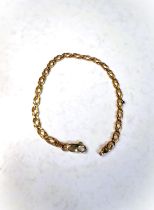 A yellow metal flattened link bracelet stamped 9K, 4.7gm