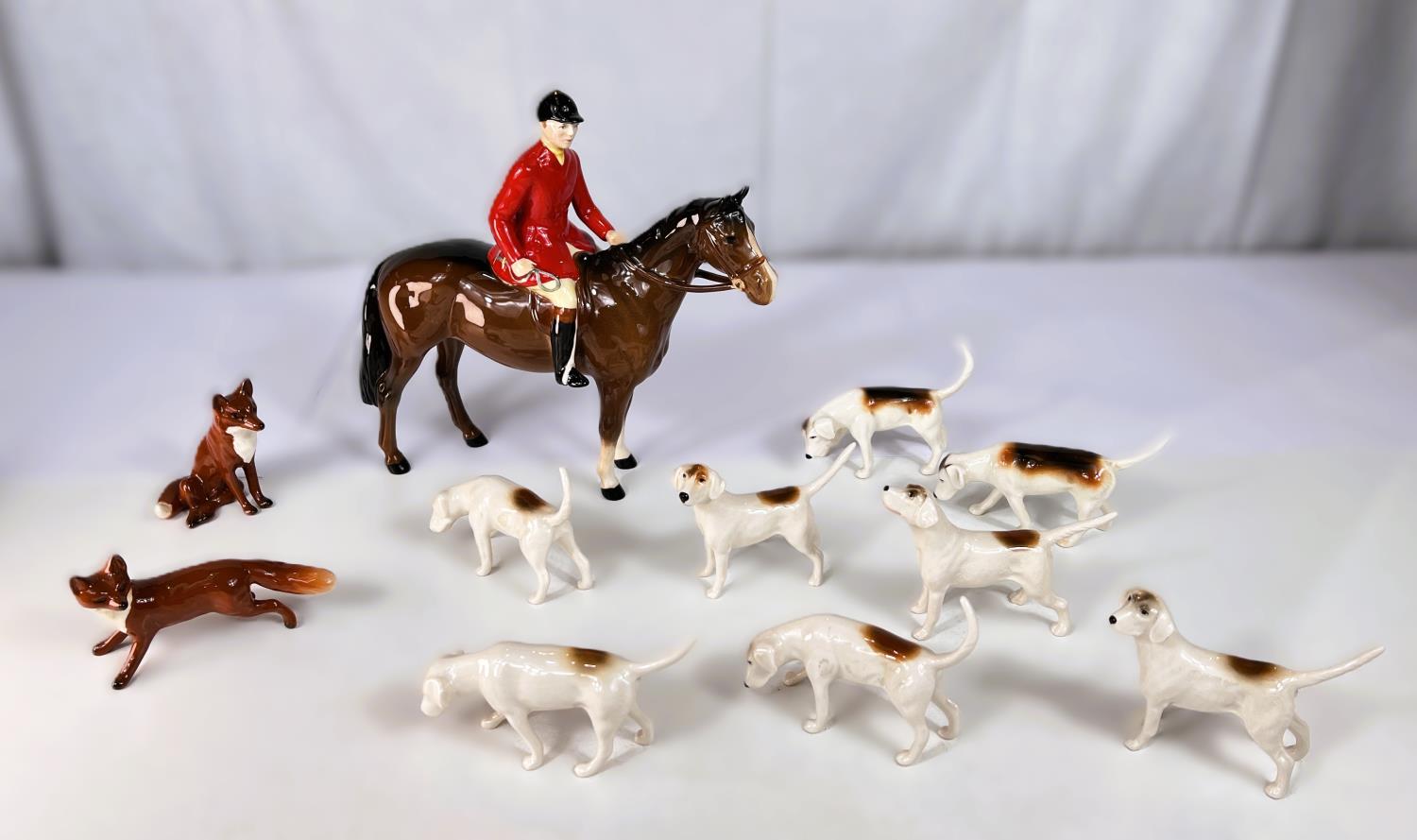 A Beswick Fox Hunting set of huntsmen, 8 hounds and 2 foxes