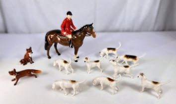 A Beswick Fox Hunting set of huntsmen, 8 hounds and 2 foxes