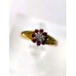 An 18 carat hallmarked gold dress ring illusion set with red and clear stones, 2.8gm size N/O