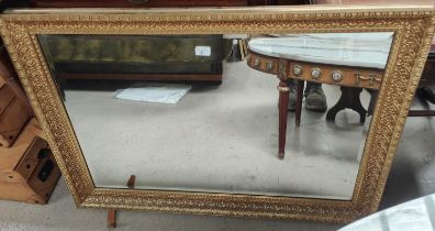 A rectangular gilt framed wall mirror; an oval oak framed wall mirror