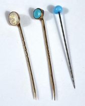 A cased opal and 9ct gold stick pin and two others set with Turquoise stones cased