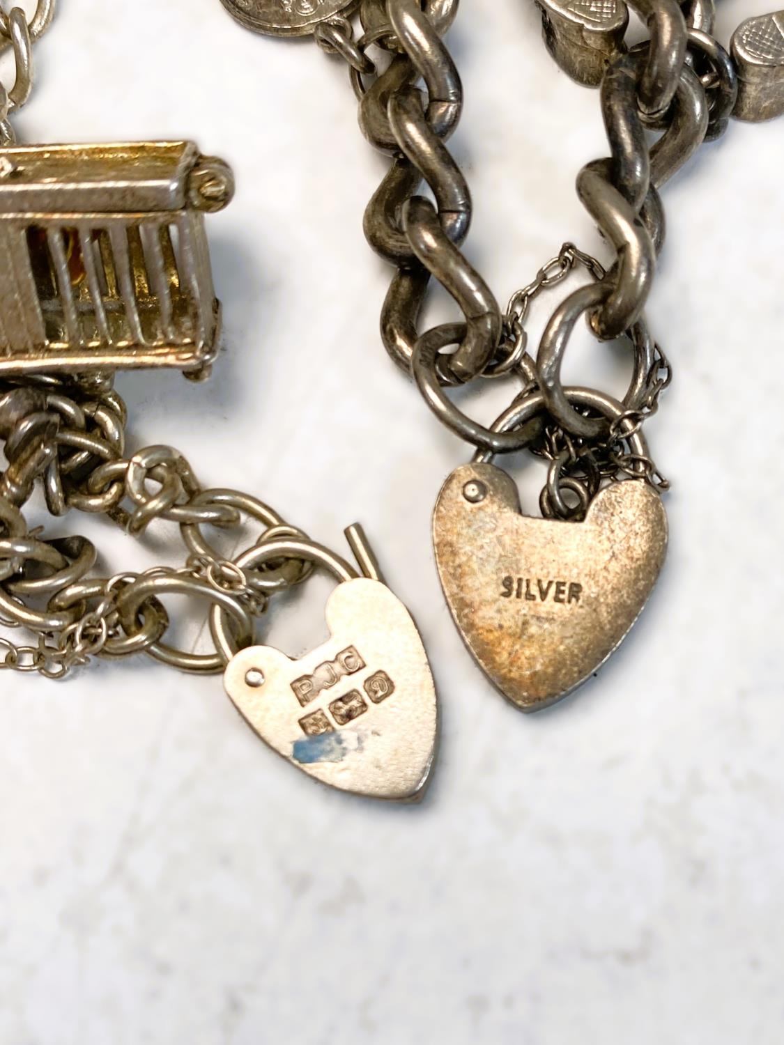 A white metal bark effect ring set with garnets; 2 white metal charm bracelets, pendants etc - Image 2 of 2