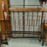 A Victorian brass bed frame with circular finials and side irons
