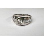 A gent's white metal dress ring with central diamond approx. 0.7 carats on broad shank, each