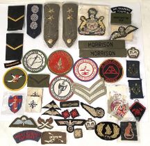 A collection of military cloth shoulder badges and patches for various regiments etc